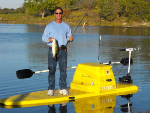 Roy Sanders on a flatstalker fishing for bass on a ranch lake